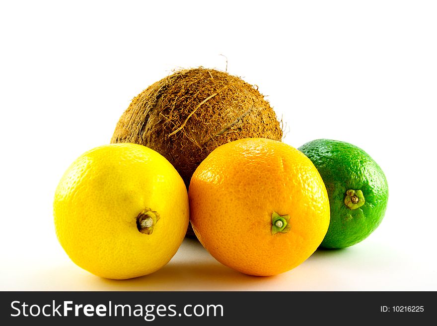 Single whole lemon, lime, orange and coconut with a white background