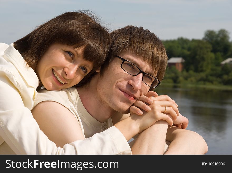 Boy and girl on the river`s bank