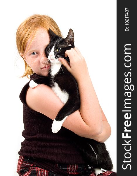 Girl is cuddling with a young cat isolated on white