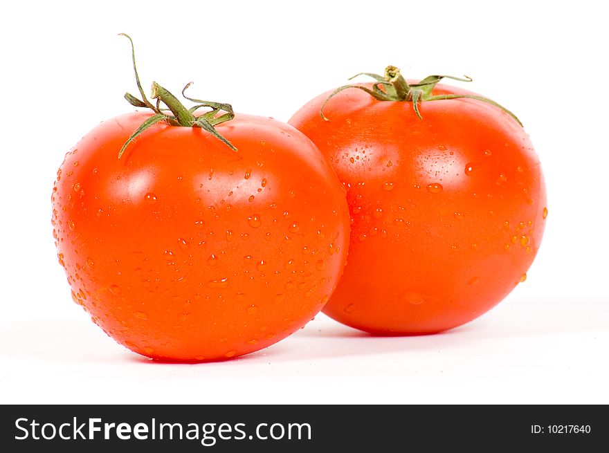 Two fresh tomatos isolated on a white background