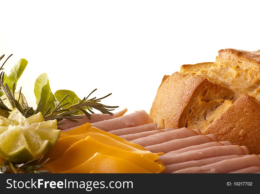 An italian bread with some slices of ham and cheese, over an white background. An italian bread with some slices of ham and cheese, over an white background