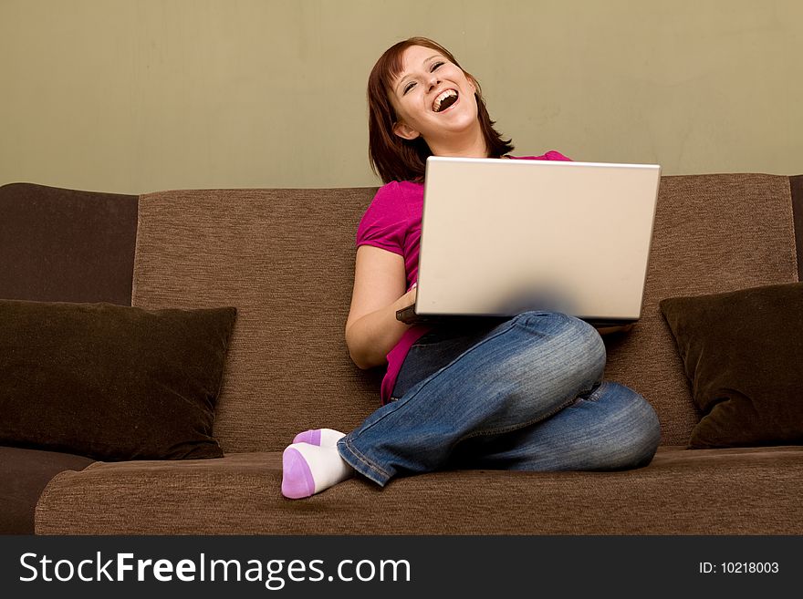 Woman with laptop on sofa