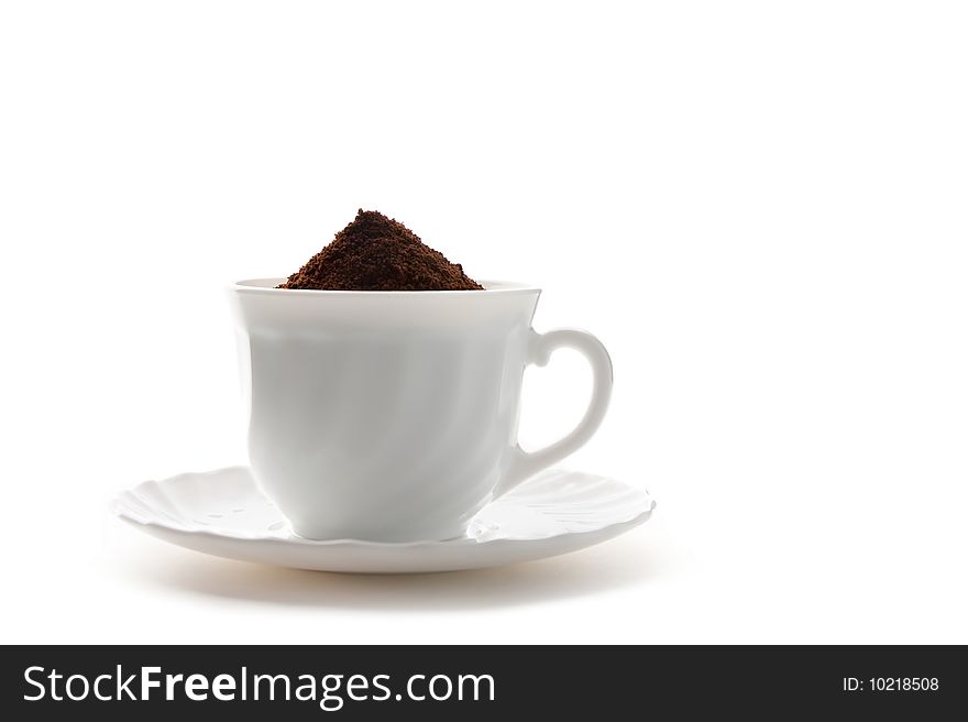 Cup of ground coffee is isolated against a white background. Cup of ground coffee is isolated against a white background