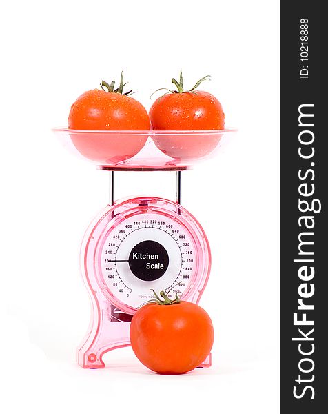 Kitchen Scales with fresh tomatoes isolated over white