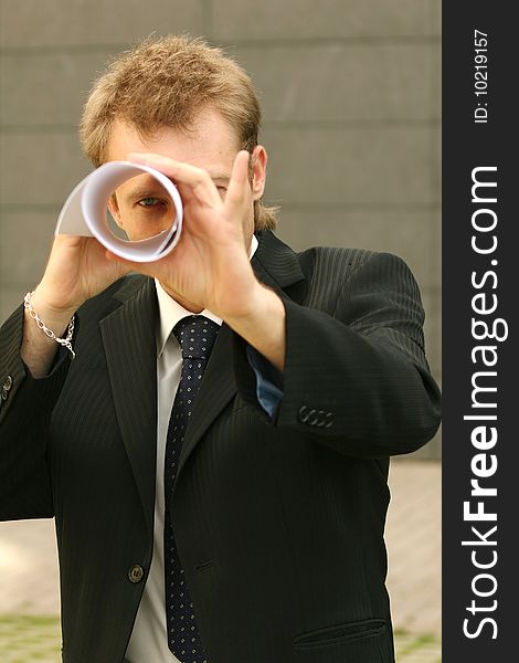 Man Looking Through Paper