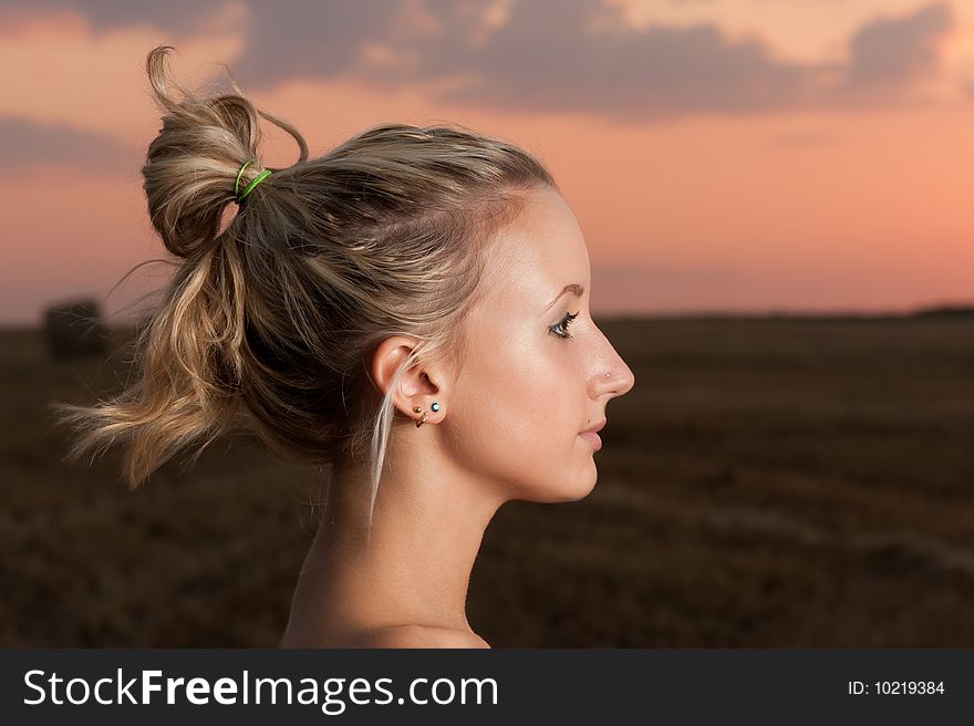 Beautiful blond girl outdoor portrait at sunset. Beautiful blond girl outdoor portrait at sunset