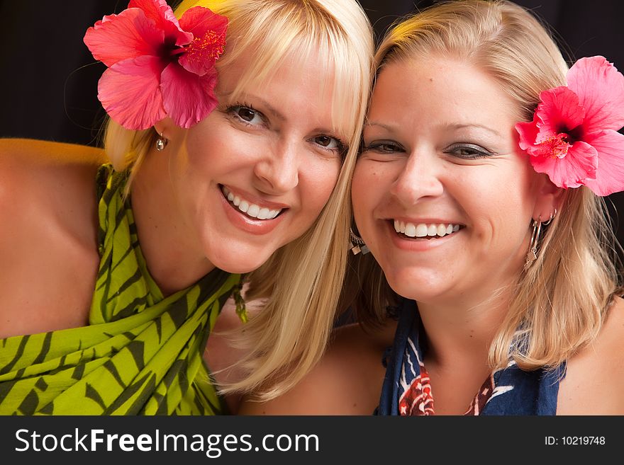 Beautiful Smiling Girls with Hibiscus Flowers in Their Hair.