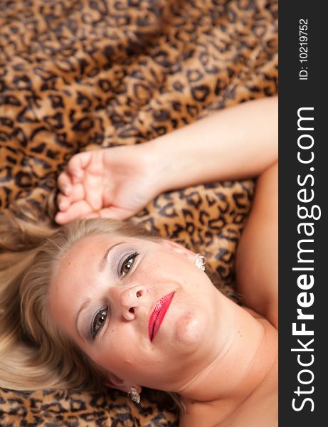 Beautiful Blonde Model Poses on Leopard Blanket. Beautiful Blonde Model Poses on Leopard Blanket.