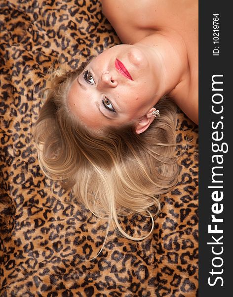 Beautiful Blonde Woman Poses On Leopard Blanket.
