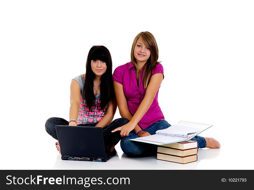 Teenager girls studying with computer and books on white background