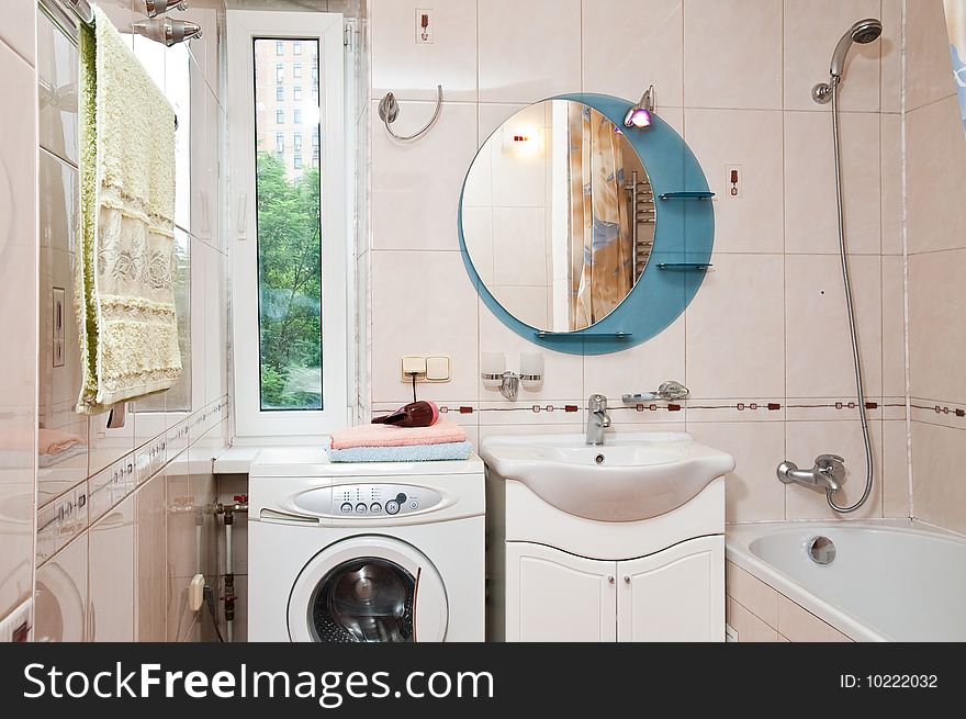 Lamp and mirror on a wall of bathroom