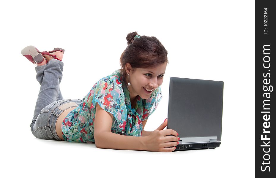 Cute young woman with laptop. Studio shot