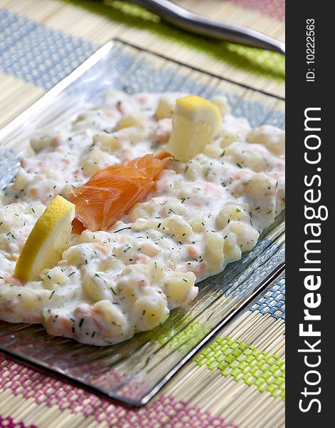 Potato halusky (dumplings) with smoked salmon (Slovakian cuisine)