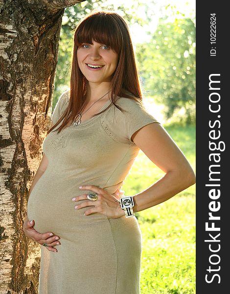 Happy pregnant woman relaxing outdoors. Happy pregnant woman relaxing outdoors