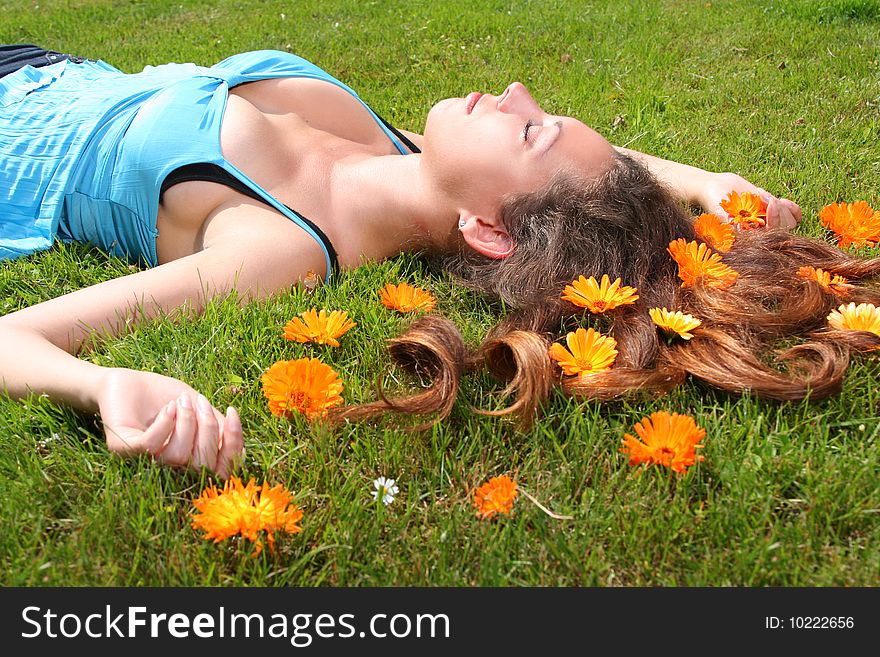 Beautiful young woman relaxing on a grass. Beautiful young woman relaxing on a grass