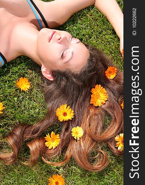 Beautiful young woman relaxing on a grass. Beautiful young woman relaxing on a grass