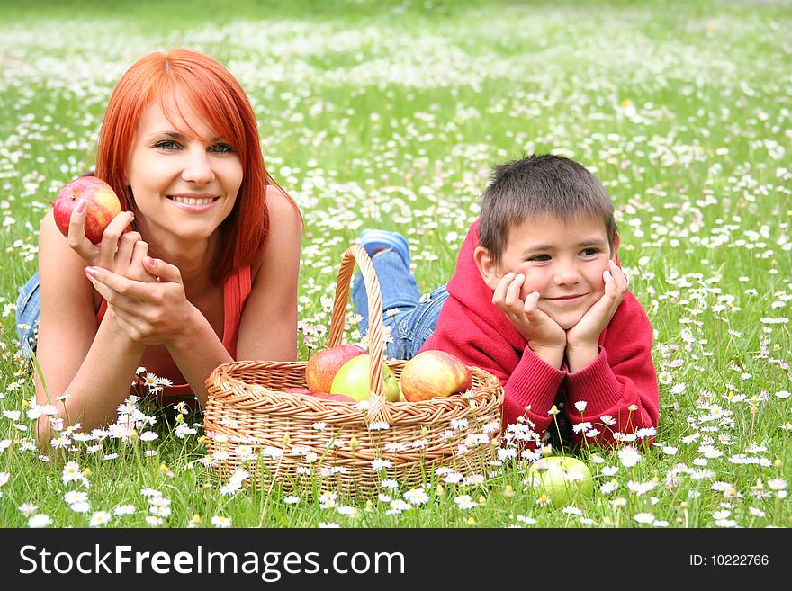 Happy young family relaxing on a meadow. Happy young family relaxing on a meadow
