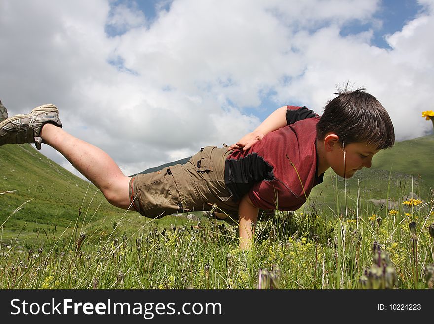Boy dances on the meadow
