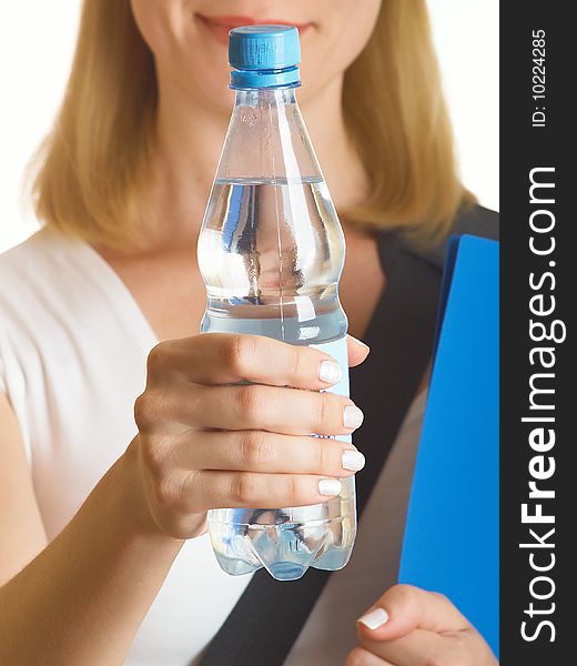 It holds a bottle with water on the white background. It holds a bottle with water on the white background
