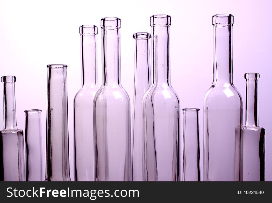A nice set of different shaped bottles on a withe background