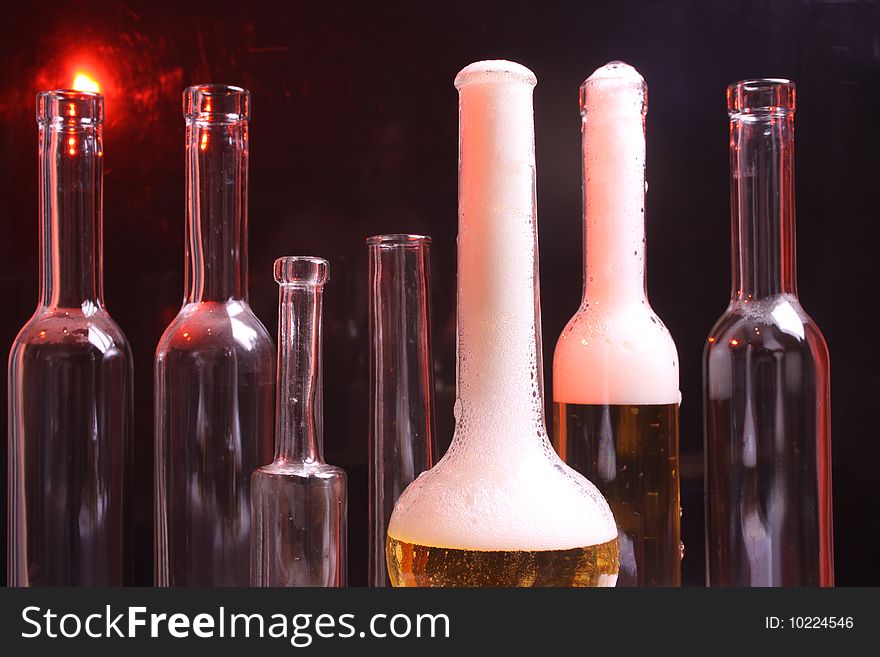 A nice set of different shaped bottles on a black background. A nice set of different shaped bottles on a black background