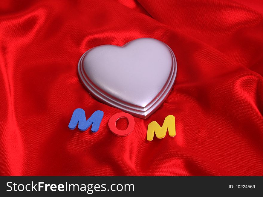 Mom and a silver heart on red satin