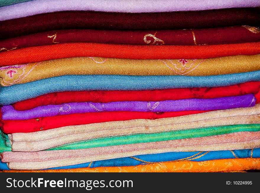 A stack of colourful embroidered Arabian Shawls. A stack of colourful embroidered Arabian Shawls
