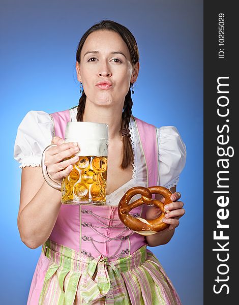 A young Bavarian girl partying at Oktoberfest with a mass of beer and Brezn