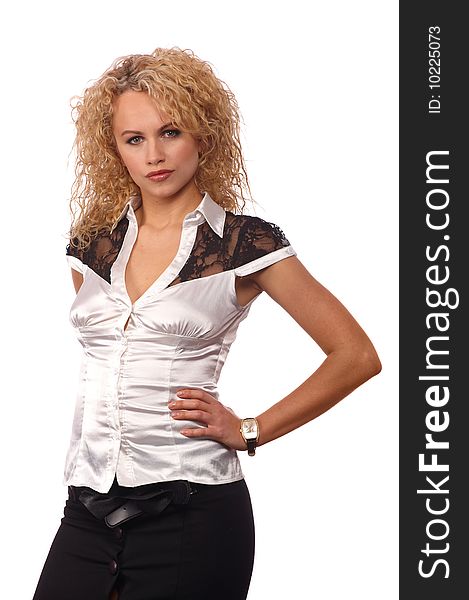Young beautiful girl in a white blouse and black skirt with a  curly blond hair on a white background. Young beautiful girl in a white blouse and black skirt with a  curly blond hair on a white background