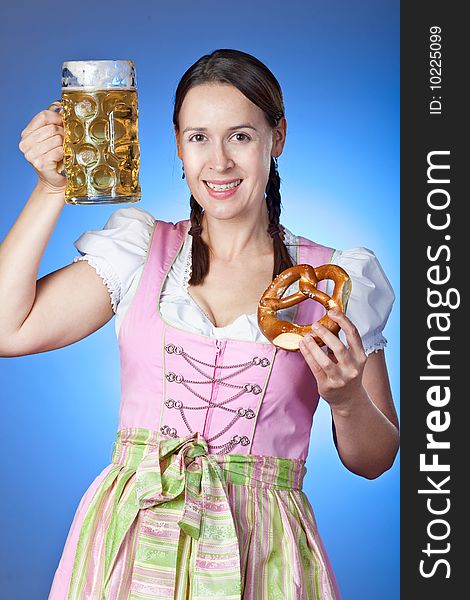 A young Bavarian girl celebrating Oktoberfest with a mass of beer. A young Bavarian girl celebrating Oktoberfest with a mass of beer