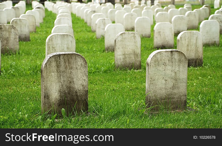 Old White Tombstones In A Cemetery.