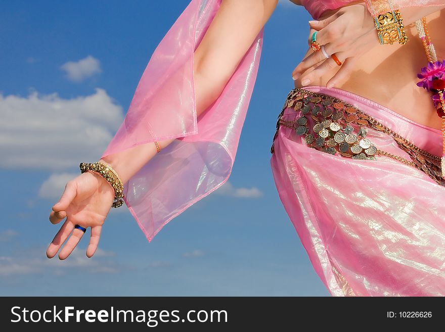 Womans body in pink asian dress and  accessorys details. Womans body in pink asian dress and  accessorys details