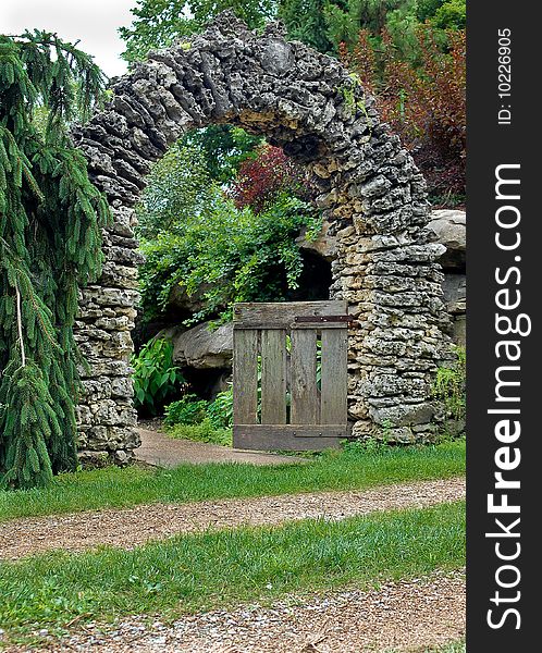 Stacked rock arch with wooden gate