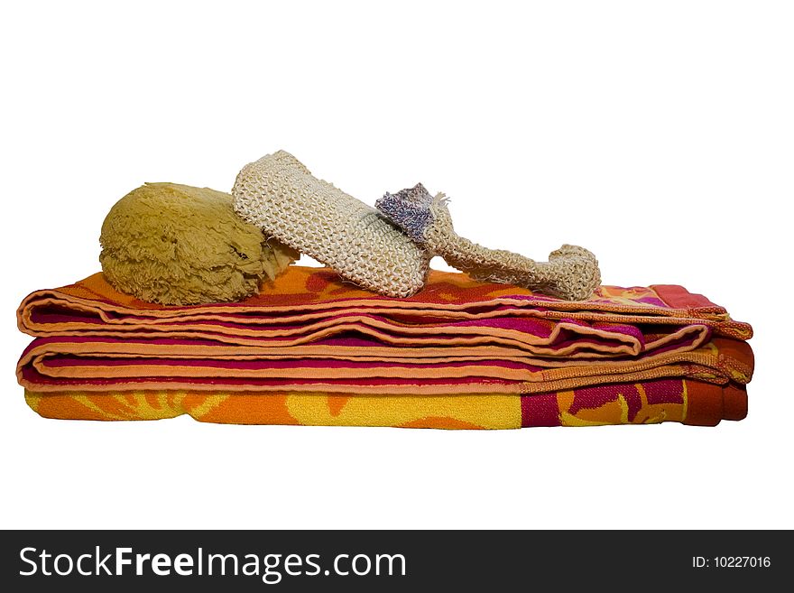 Towel, sponge and glove indicating that a spa treatment is coming. Isolated on white. Towel, sponge and glove indicating that a spa treatment is coming. Isolated on white.