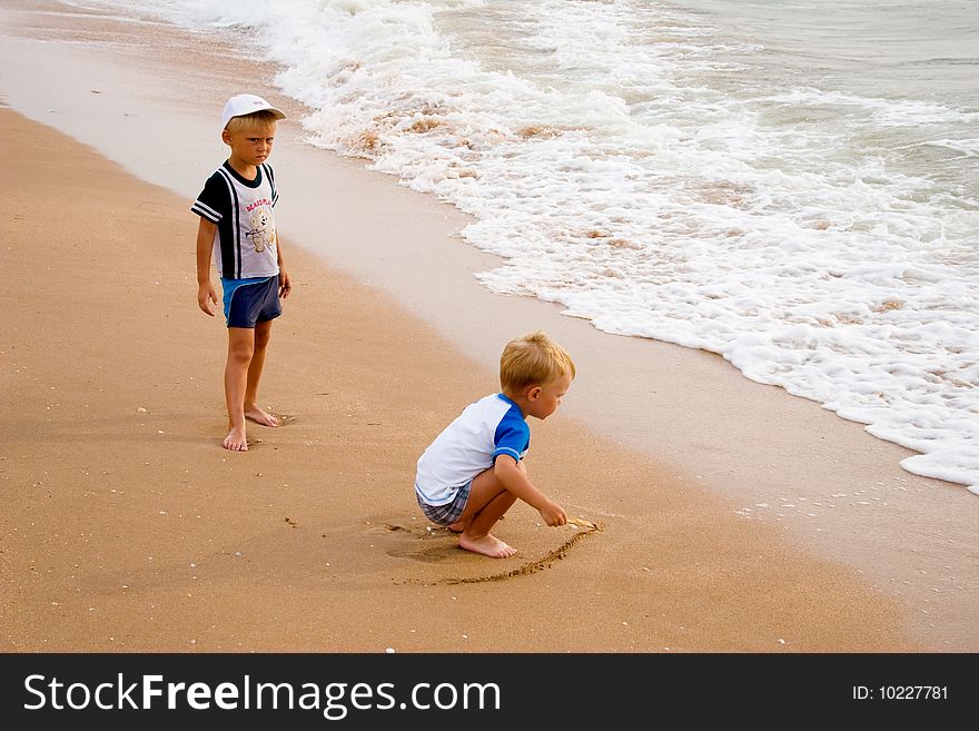 Little boys walking on sea coast. Little boys walking on sea coast.