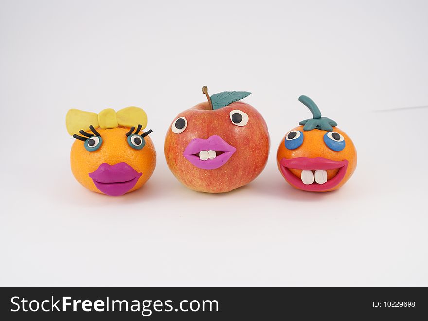 Funny fruit manikins. Apple and two mandarines. Funny fruit manikins. Apple and two mandarines.