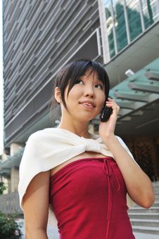 Asian Chinese Woman Answering Her Mobile Phone Royalty Free Stock Image