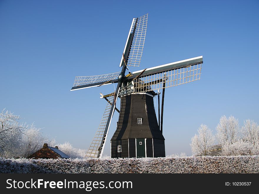 Windmill in nisse with cold blue sky
