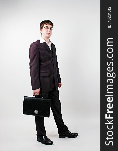 Young businessman with bag on white. Young businessman with bag on white