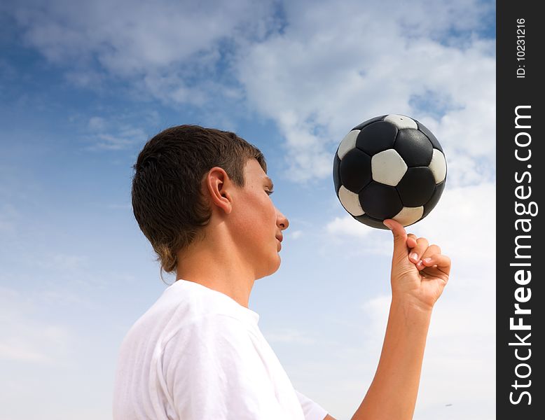 A teenager twists a ball