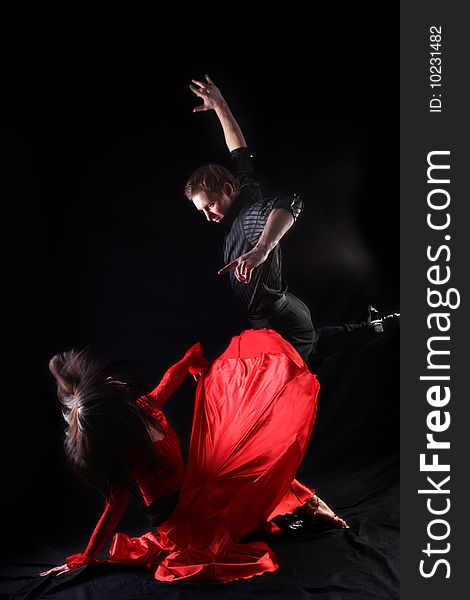 Dancers in action against black background