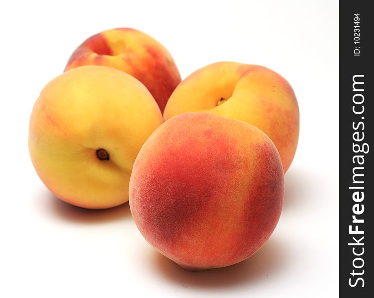 Ripe sweet peaches on white backgroun