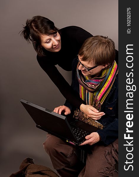 Smiling couple together with laptop isolated