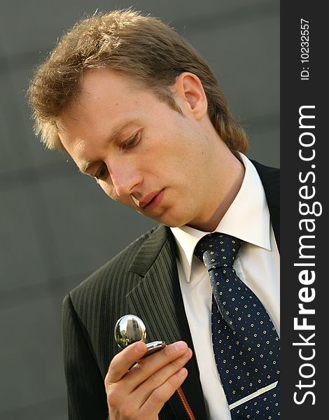 Businessman looking at his pocket watch. Businessman looking at his pocket watch