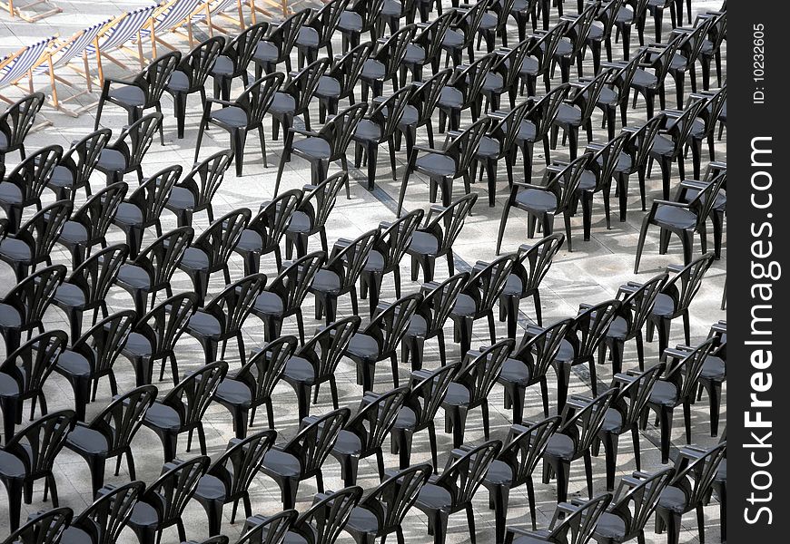Rows of black plastic chairs waiting for an audience. Rows of black plastic chairs waiting for an audience.