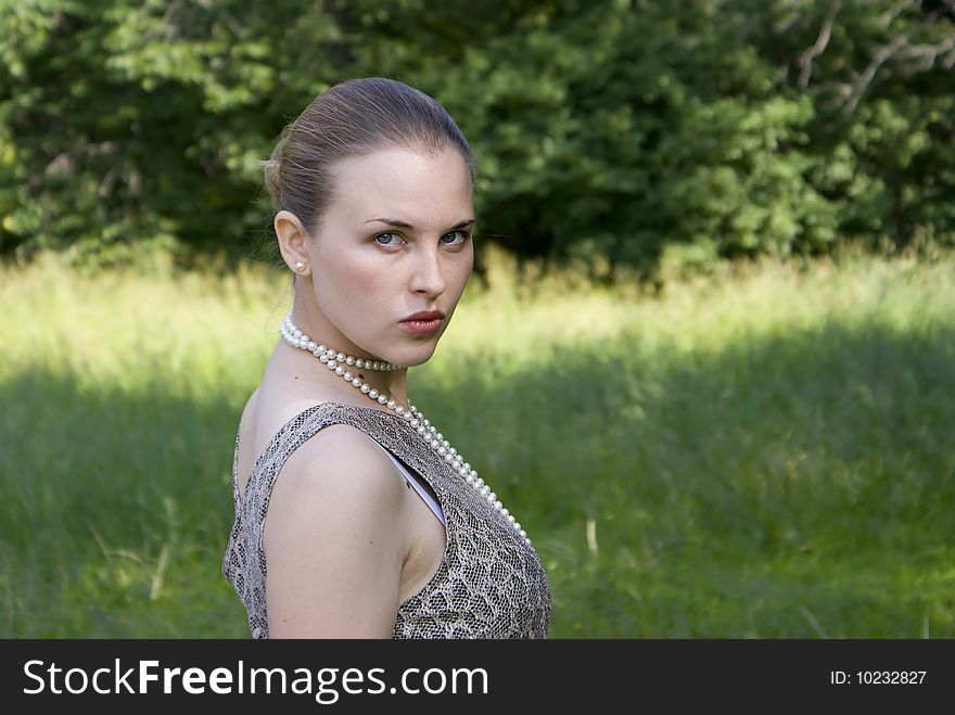 Beautiful Girl On A Green Wood Background