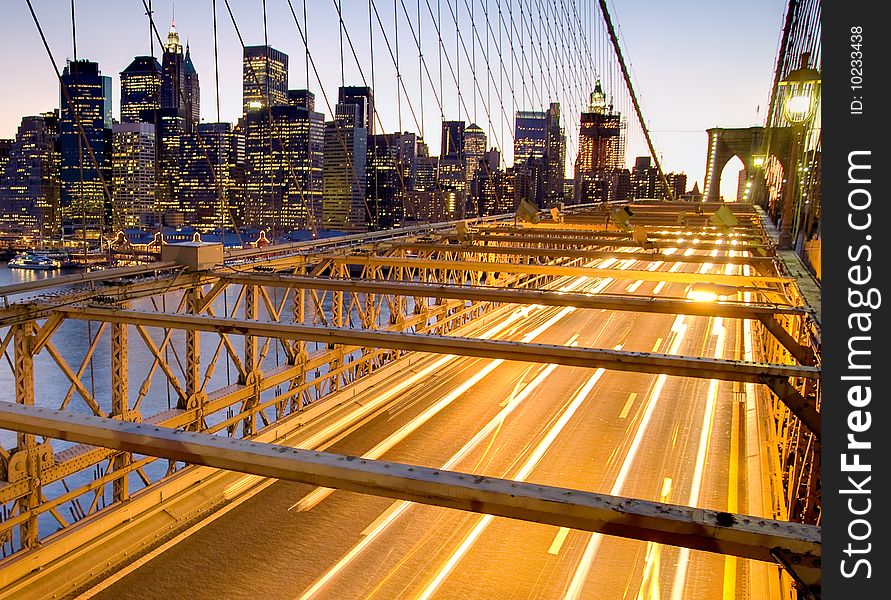 View of the Brooklyn Bridge and Financial District at Sunset in New York city, USA.