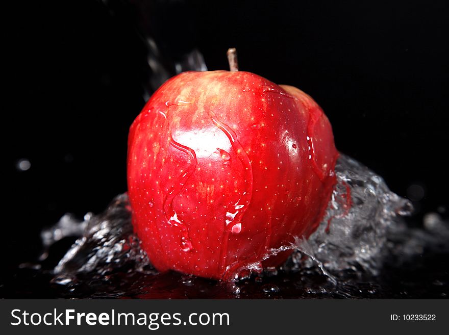 Fresh red apple in water splash