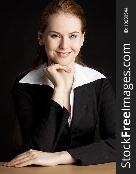 Portrait of businesswoman sitting by the table