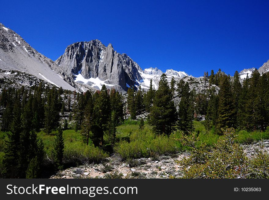 A mountain is captured under a cloudless sky in the high sierra. A mountain is captured under a cloudless sky in the high sierra